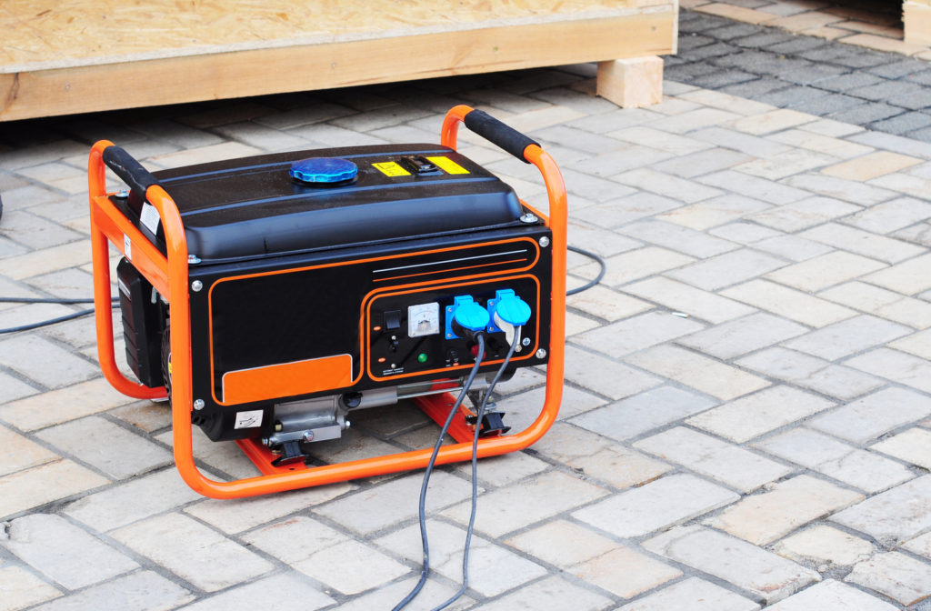 Portable Home Generator on concrete pad outside of home